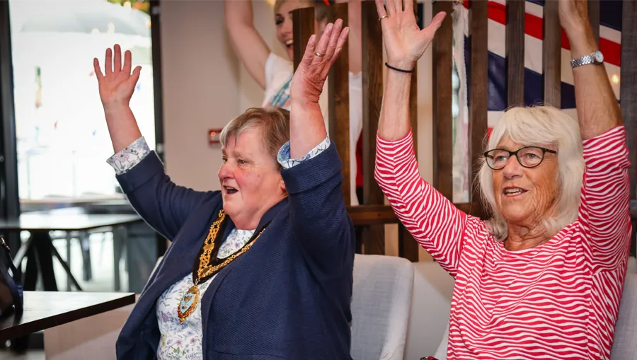 Residents cheering at a community celebration