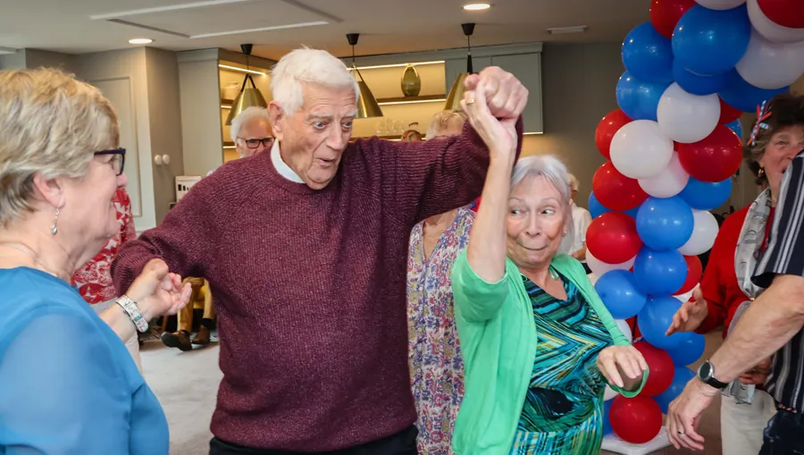 Residents dancing at a community party