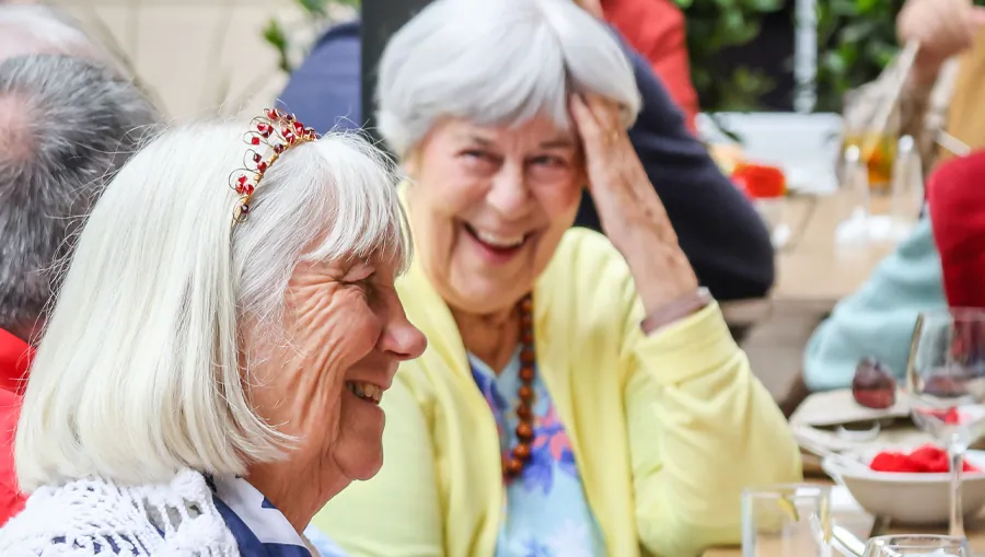 Two friends laughing together outdoors