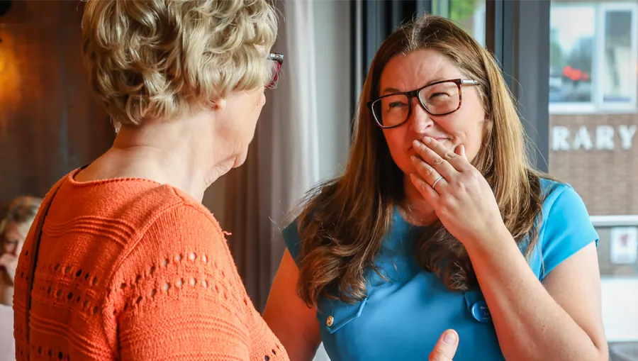 A resident in conversation at a community event