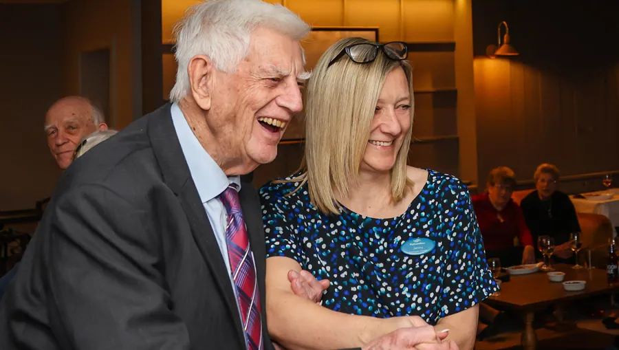 A resident laughing with an AHC team member
