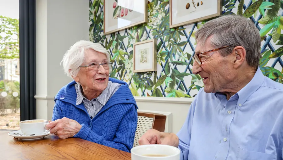 Two residents chatting over coffee