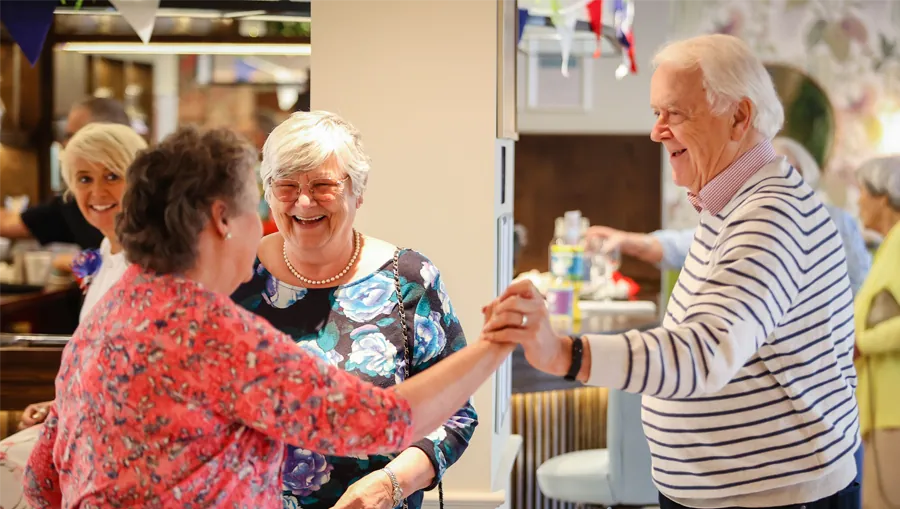 Residents dancing together at a social event