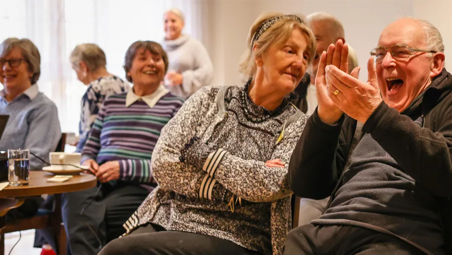 Residents laughing together at a community event